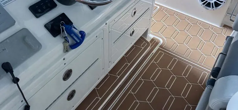  Yacht Photos Pics 2018 Cobia 344 Center Console boat interior with steering wheel and patterned flooring.