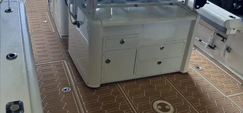  Yacht Photos Pics 2018 Cobia 344 Center Console boat interior with brown patterned flooring and white storage console.