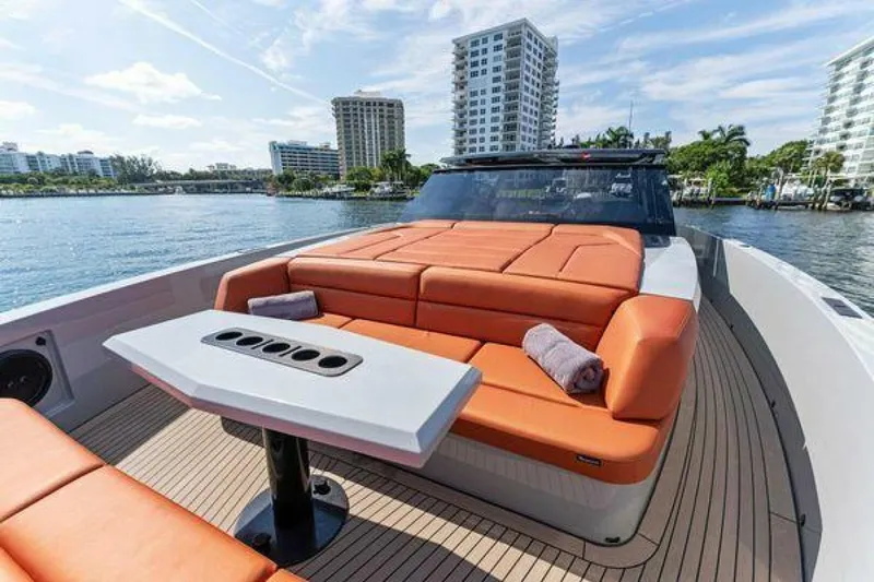 Incentivized Yacht Photos Pics Luxurious 2021 Vanquish VQ58 yacht with orange seating and waterfront view.