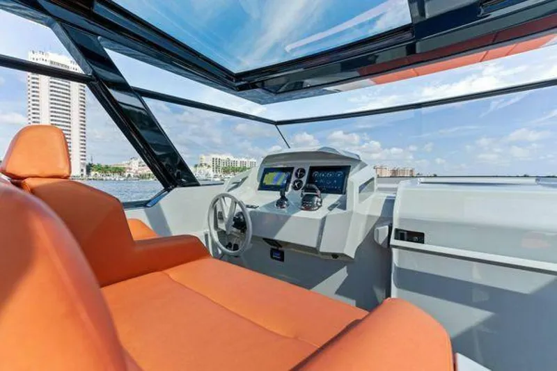 Incentivized Yacht Photos Pics Luxurious 2021 Vanquish VQ58 yacht interior with orange seating and modern dashboard.