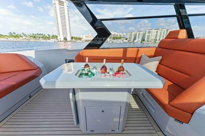Incentivized Yacht Photos Pics Luxurious 2021 Vanquish VQ58 yacht interior with orange seating and drinks on the table.