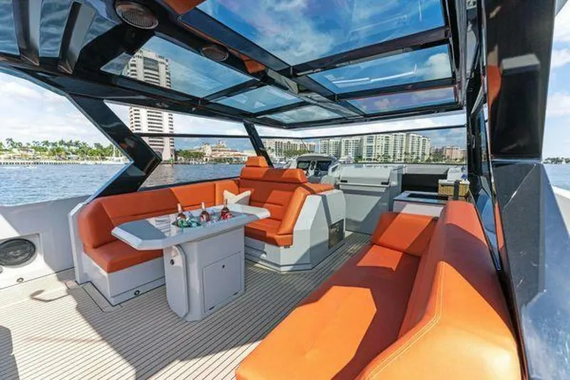 Incentivized Yacht Photos Pics Luxurious 2021 Vanquish VQ58 yacht interior with orange seating and panoramic views.
