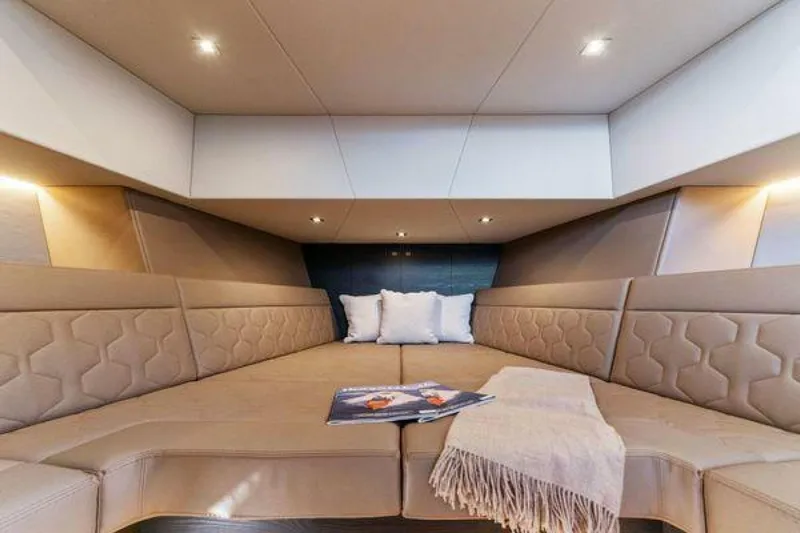 Incentivized Yacht Photos Pics Luxurious interior of 2021 Vanquish VQ58 yacht with cozy seating and elegant decor.