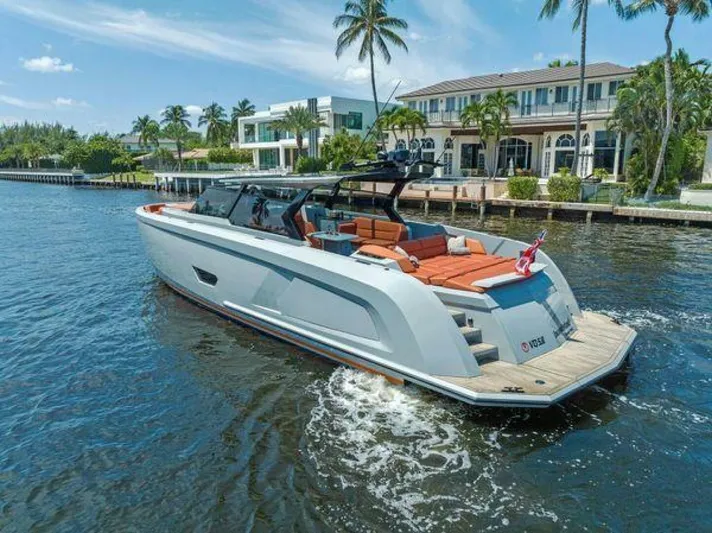 Incentivized Yacht Photos Pics Luxury 2021 Vanquish VQ58 yacht cruising near waterfront homes and palm trees.