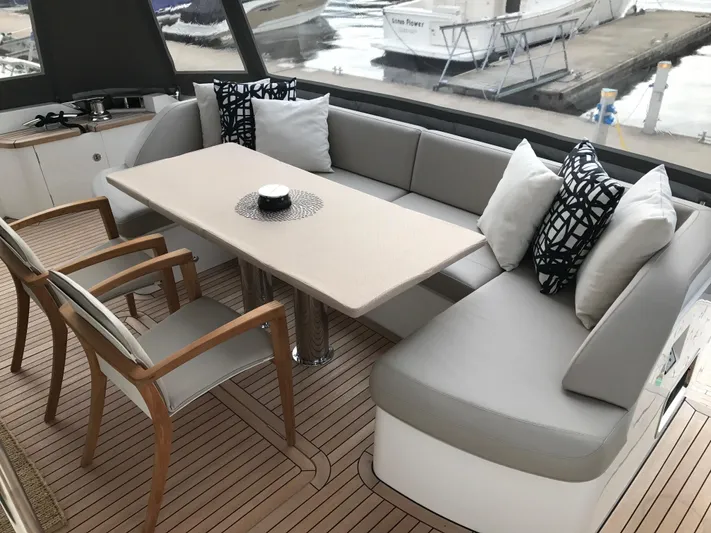  Yacht Photos Pics Luxurious seating area on 2017 Princess 68 yacht with elegant cushions and wooden deck.