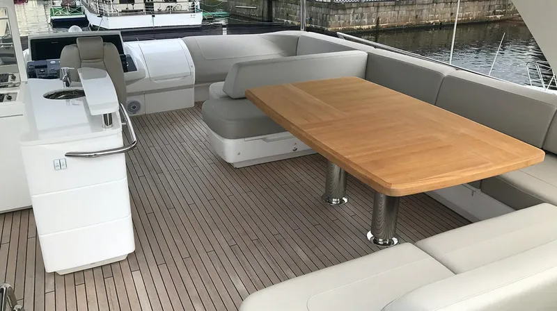  Yacht Photos Pics Luxurious 2017 Princess 68 yacht deck with wooden table and cushioned seating.