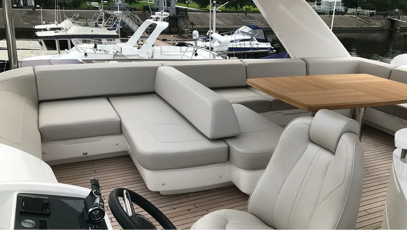  Yacht Photos Pics Luxurious seating area on 2017 Princess 68 yacht with elegant design and wooden table.