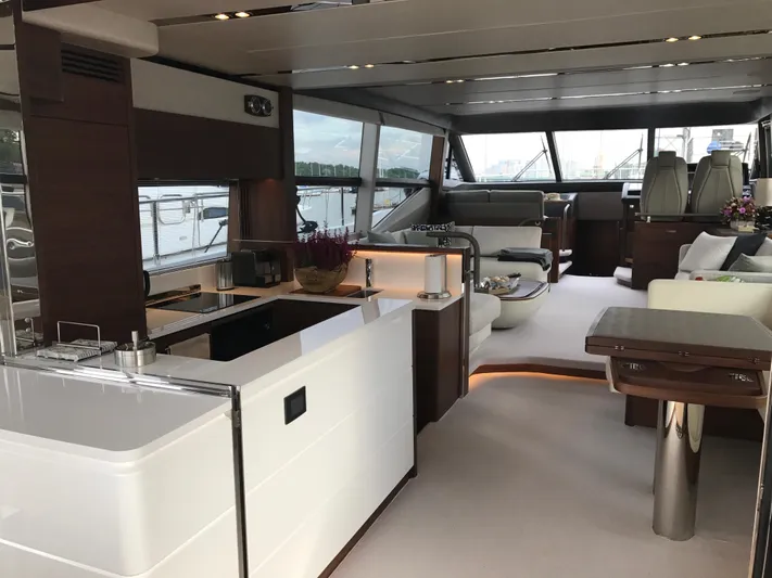  Yacht Photos Pics Luxurious interior of 2017 Princess 68 yacht with modern kitchen and seating area.