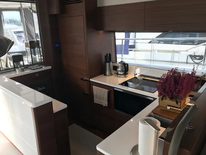  Yacht Photos Pics Luxurious kitchen interior of 2017 Princess 68 yacht with modern appliances and sleek design.