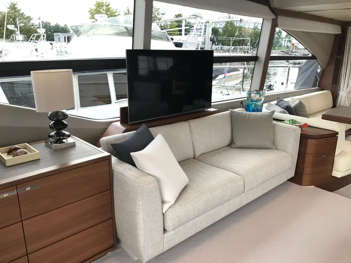  Yacht Photos Pics Luxurious 2017 Princess 68 yacht interior with modern sofa, TV, and elegant decor.
