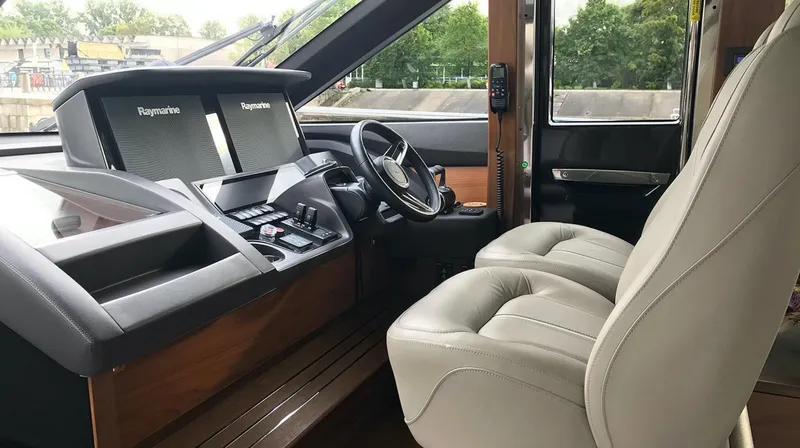  Yacht Photos Pics Interior of a 2017 Princess 68 yacht with modern navigation equipment and luxurious seating.