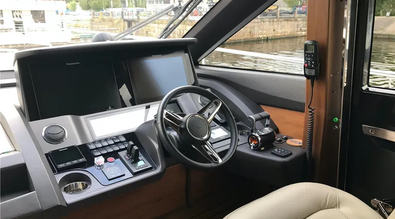  Yacht Photos Pics Luxurious 2017 Princess 68 yacht helm with advanced navigation controls and steering wheel.