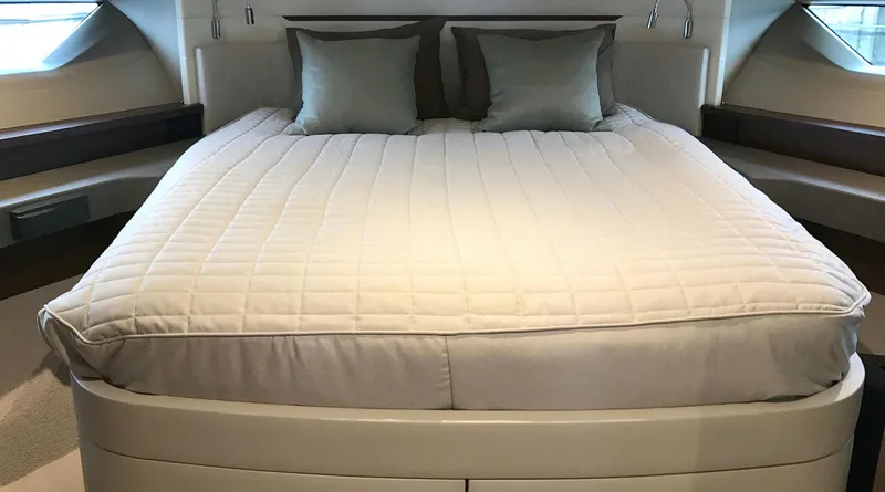  Yacht Photos Pics Luxurious bedroom interior of 2017 Princess 68 yacht with elegant bedding.
