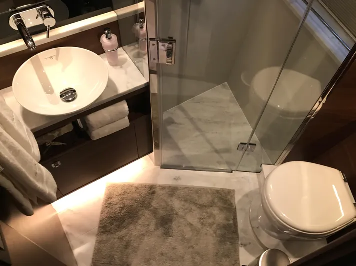  Yacht Photos Pics Luxurious bathroom in 2017 Princess 68 yacht with modern fixtures and glass shower.