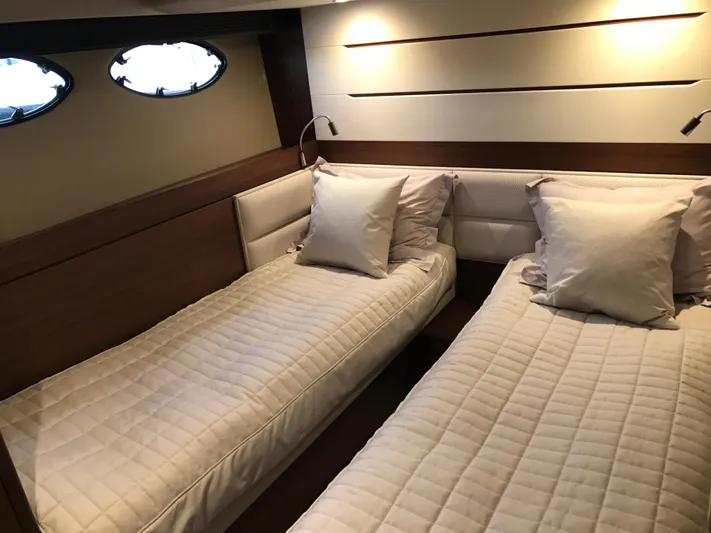  Yacht Photos Pics Luxurious twin cabin in 2017 Princess 68 yacht with elegant bedding and ambient lighting.
