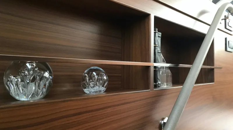  Yacht Photos Pics Wooden interior shelves with decorative glass items on a 2017 Princess 68 yacht.
