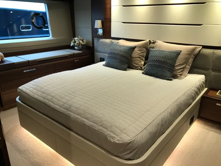  Yacht Photos Pics Luxurious bedroom interior of 2017 Princess 68 yacht with elegant bedding and ambient lighting.