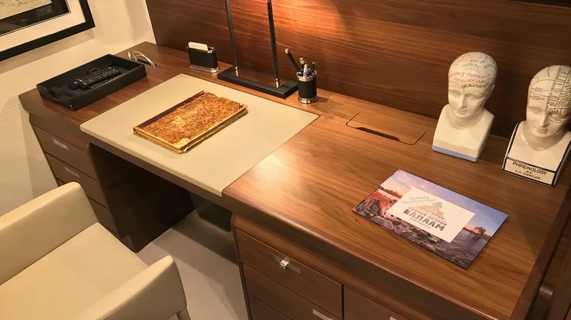  Yacht Photos Pics Luxurious wooden desk on Princess 68 yacht, featuring elegant decor and modern accessories.