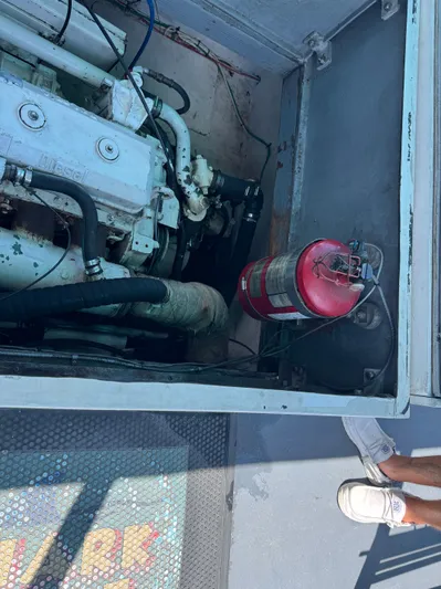 Mega Bite Yacht Photos Pics Engine compartment of 1986 Willard Marine Shark Boat 40', featuring fire extinguisher and visible engine components.