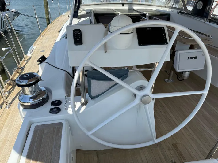 Blue Pearl Yacht Photos Pics Steering wheel of 2016 Beneteau Oceanis 60 yacht, featuring modern navigation equipment.