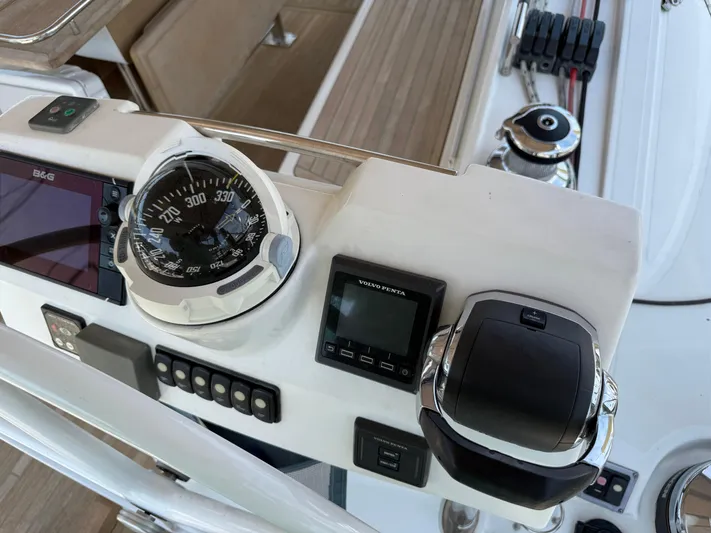 Blue Pearl Yacht Photos Pics Control panel of a 2016 Beneteau Oceanis 60 sailboat with compass and navigation instruments.