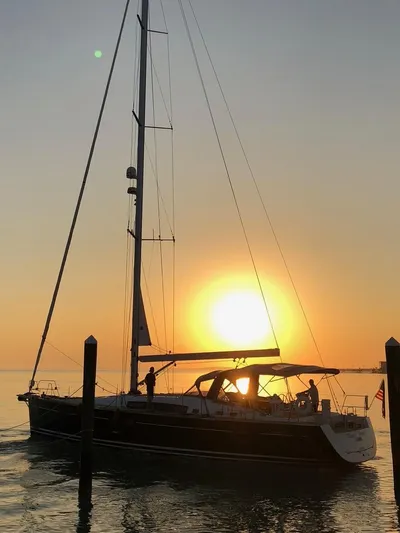 Blue Pearl Yacht Photos Pics Sailing yacht Beneteau Oceanis 60, 2016 model, at sunset on calm waters.