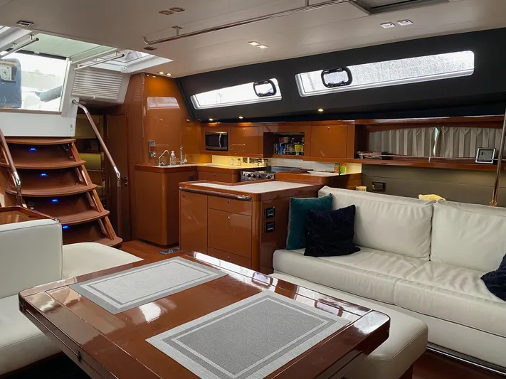 Blue Pearl Yacht Photos Pics Luxurious interior of 2016 Beneteau Oceanis 60 yacht with modern kitchen and seating area.