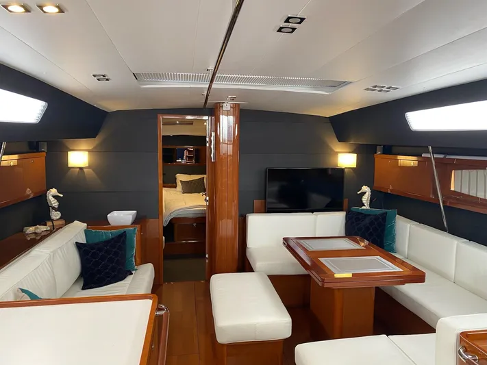 Blue Pearl Yacht Photos Pics Luxurious interior of 2016 Beneteau Oceanis 60 yacht with elegant seating and modern decor.