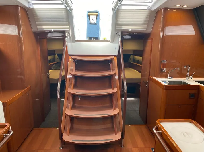 Blue Pearl Yacht Photos Pics Interior of 2016 Beneteau Oceanis 60 yacht with wooden stairs and modern kitchen area.