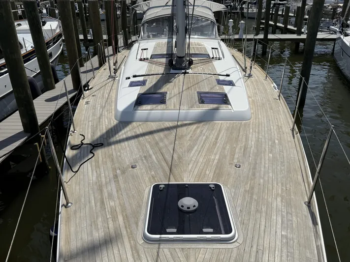 Blue Pearl Yacht Photos Pics 2016 Beneteau Oceanis 60 yacht with spacious teak deck, docked at marina.