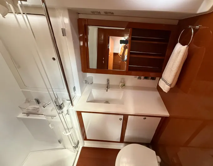 Blue Pearl Yacht Photos Pics Luxurious bathroom in 2016 Beneteau Oceanis 60 yacht with modern fixtures and wood accents.
