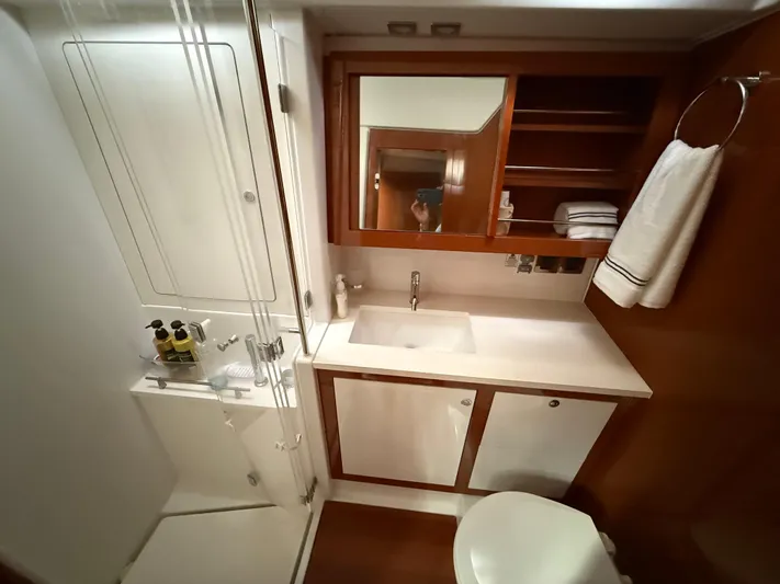 Blue Pearl Yacht Photos Pics Luxurious bathroom in 2016 Beneteau Oceanis 60 yacht with modern fixtures and wooden accents.