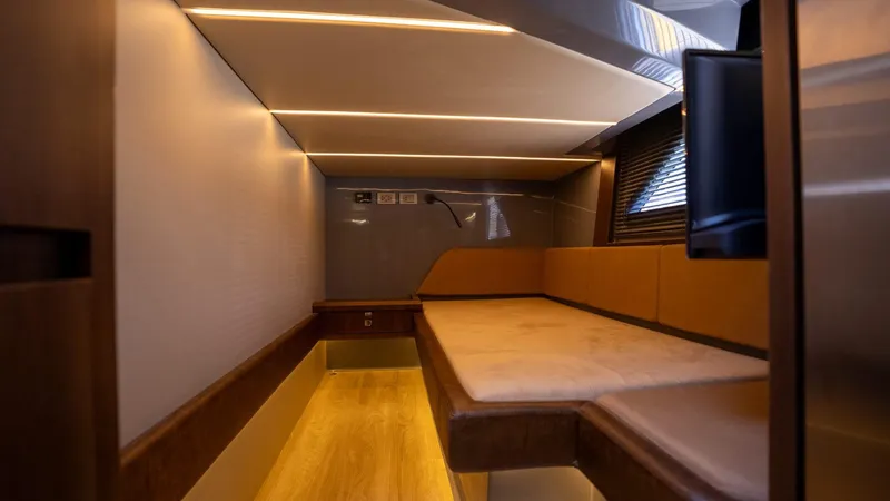  Yacht Photos Pics Luxurious interior cabin of 2025 Hanover 447 with modern lighting and comfortable seating.
