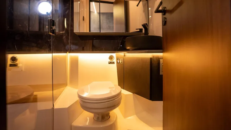  Yacht Photos Pics Luxurious bathroom interior in 2025 Hanover 447 model, featuring modern fixtures and ambient lighting.