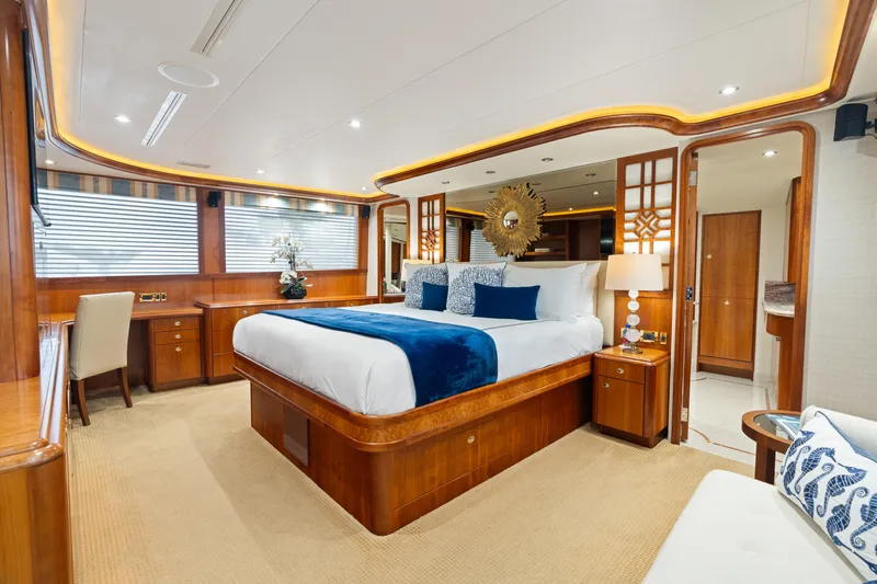 Elysian Yacht Photos Pics Luxurious bedroom on 2004 Westport 130 Tri-Deck Motor Yacht with elegant wood finishes.