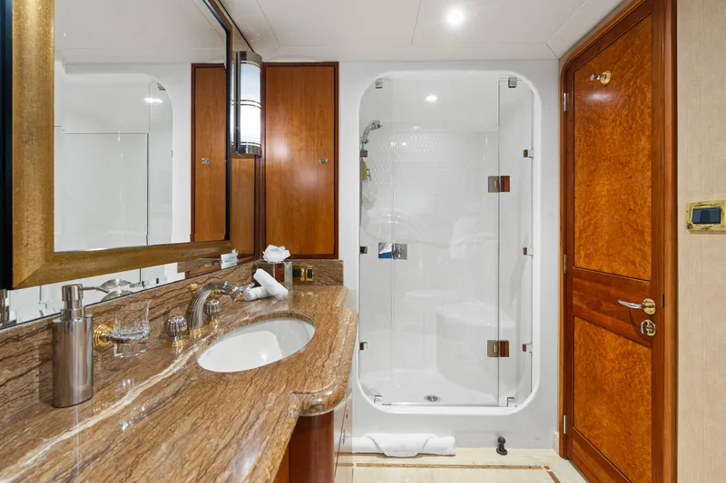 Elysian Yacht Photos Pics Luxurious bathroom on 2004 Westport 130 Tri-Deck Motor Yacht with marble countertop and glass shower.