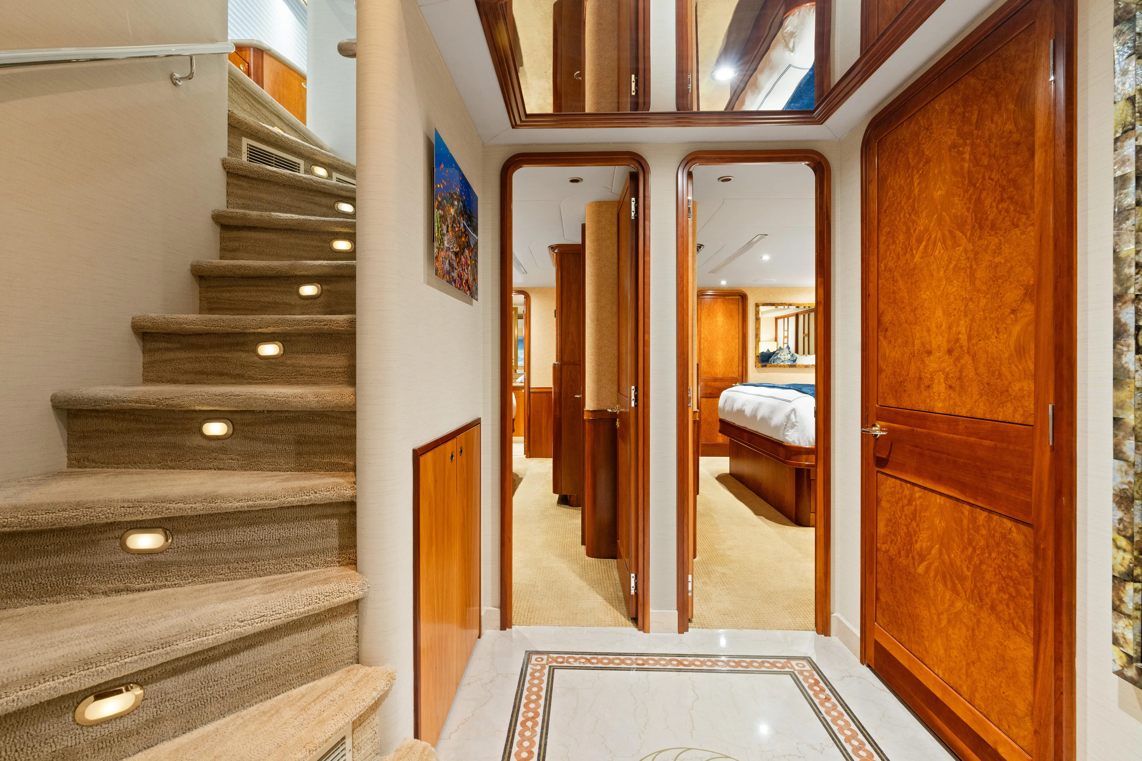 Elysian Yacht Photos Pics Luxurious interior of 2004 Westport 130 Tri-Deck Motor Yacht with elegant staircase and wood finishes.