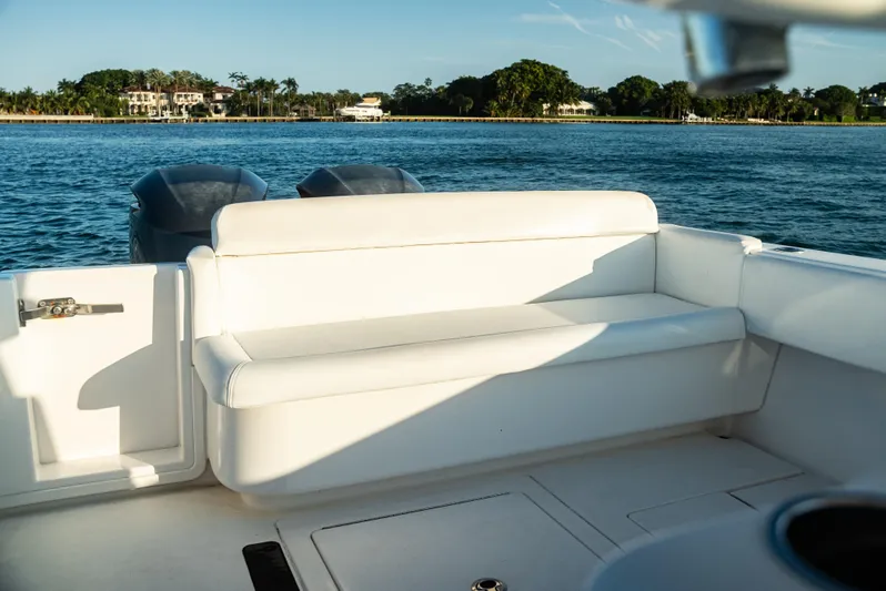  Yacht Photos Pics 2015 Contender 32 ST boat interior with white seating, ocean view in background.