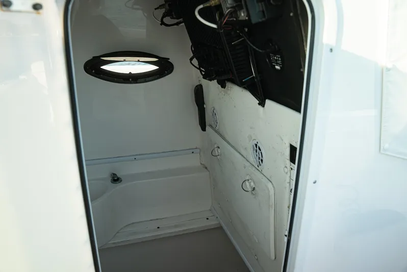  Yacht Photos Pics Interior cabin of a 2015 Contender 32 ST boat, featuring a small window and storage space.