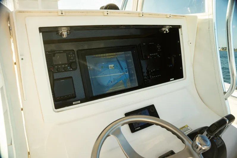  Yacht Photos Pics 2015 Contender 32 ST boat dashboard with navigation system and controls.