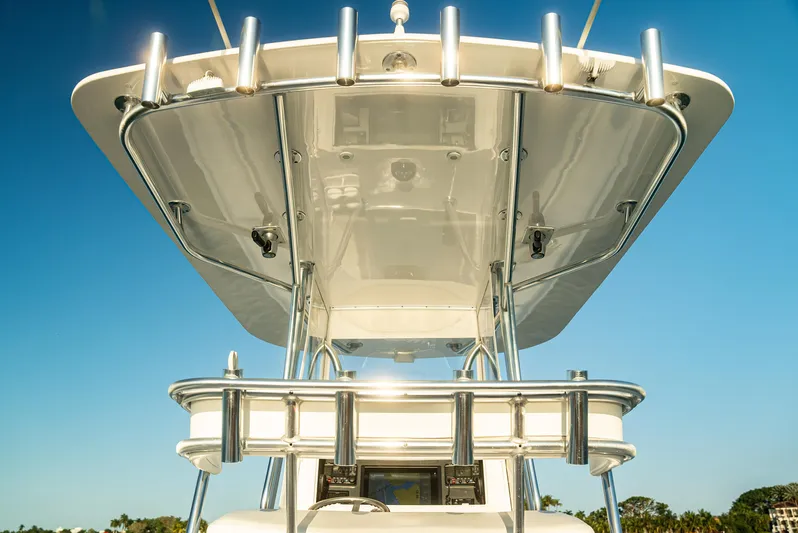  Yacht Photos Pics 2015 Contender 32 ST boat with T-top against clear blue sky.