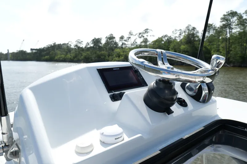 Warranty X Trailer Yacht Photos Pics 2022 Yellowfin 34 Offshore boat helm with steering wheel and navigation system.