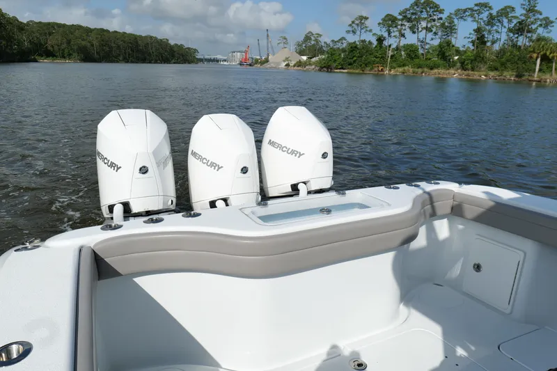Warranty X Trailer Yacht Photos Pics 2022 Yellowfin 34 Offshore boat with triple Mercury engines on a calm river.