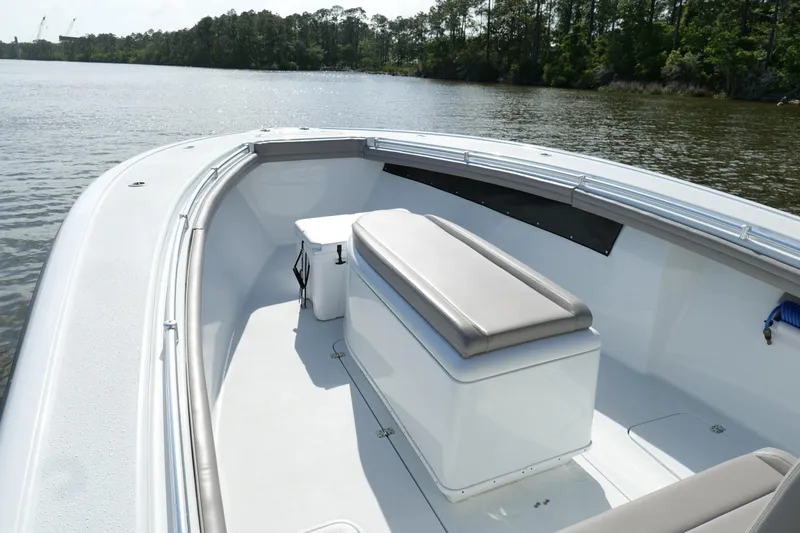 Warranty X Trailer Yacht Photos Pics 2022 Yellowfin 34 Offshore boat interior with seating, on a calm lake.