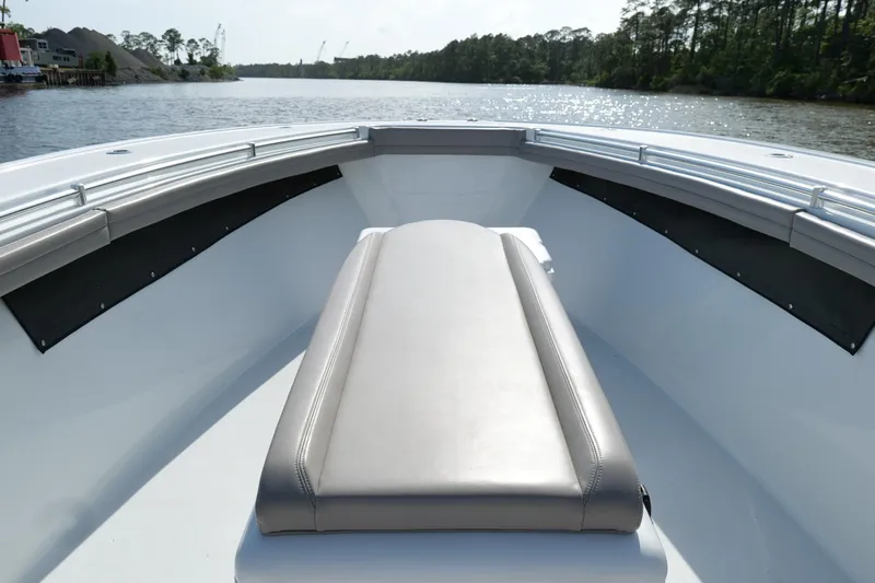 Warranty X Trailer Yacht Photos Pics 2022 Yellowfin 34 Offshore boat interior with cushioned seating, on a calm river.