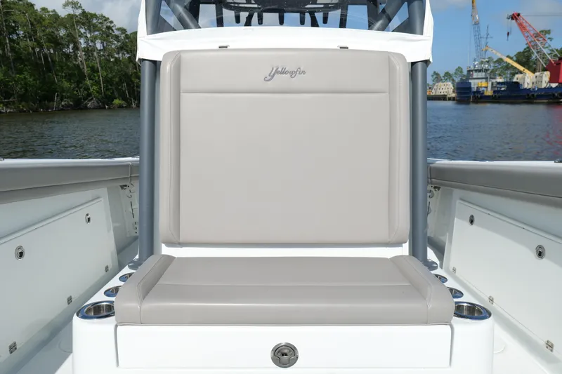Warranty X Trailer Yacht Photos Pics 2022 Yellowfin 34 Offshore boat seat with gray upholstery, docked by the water.