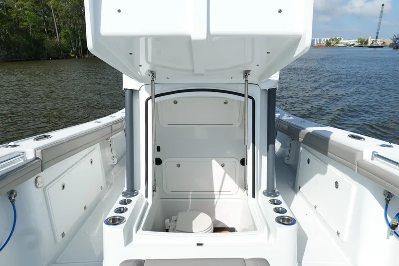 Warranty X Trailer Yacht Photos Pics 2022 Yellowfin 34 Offshore boat interior with open storage compartment on the water.