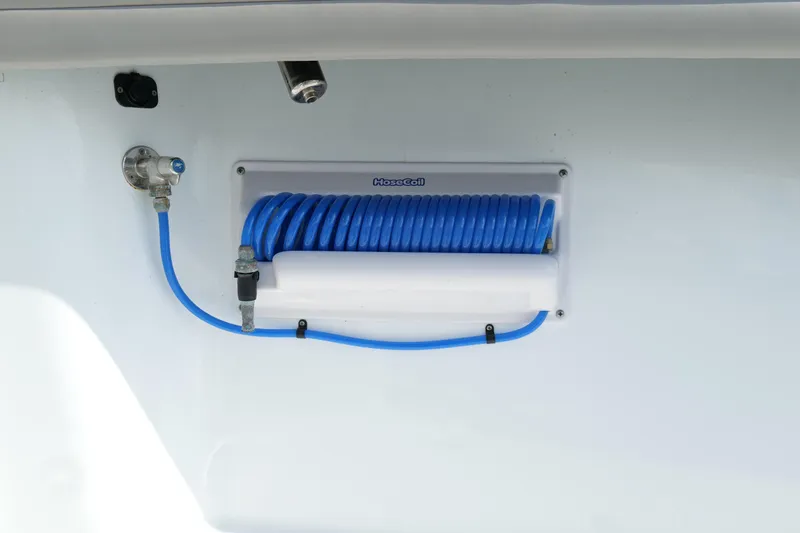 Warranty X Trailer Yacht Photos Pics Blue coiled hose on 2022 Yellowfin 34 Offshore boat, mounted on white panel.