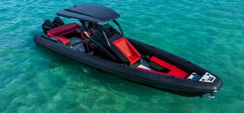  Yacht Photos Pics 2025 Novielli Veloche 349 boat on clear turquoise water, featuring sleek black and red design.