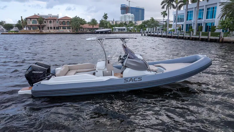  Yacht Photos Pics 2024 SACS Strider 900 boat on water, sleek design, modern architecture, urban backdrop.